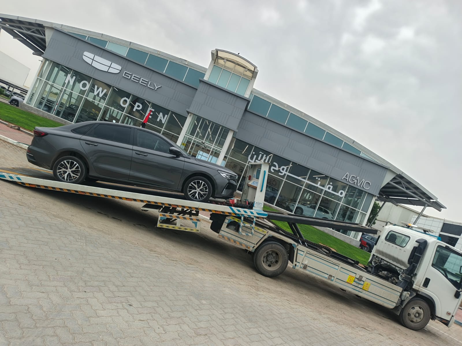 Irfan Recovery Sharjah flatbed tow truck carrying a sedan